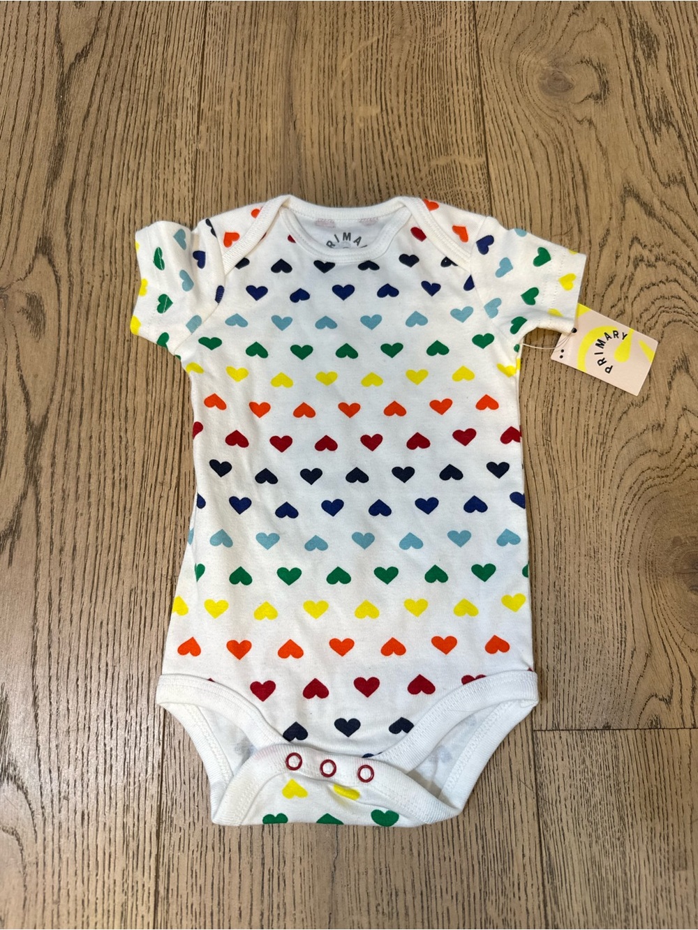 NWT Primary White Onesie with Multicolor Rainbow Heart Print